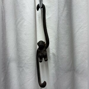 Vintage cast iron monkey hook marked "Japan".